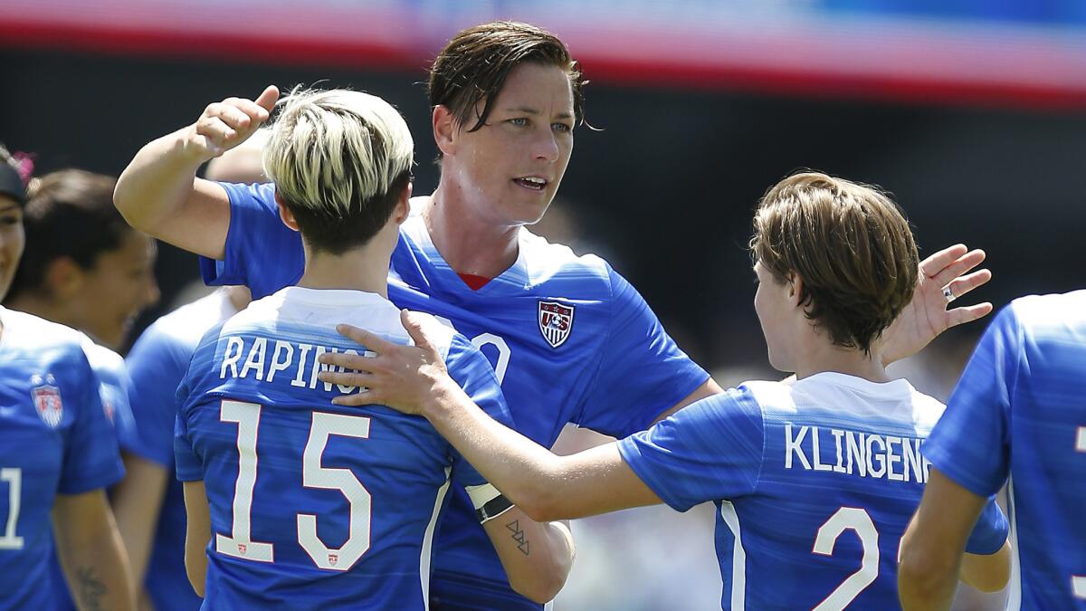 U.S. forward Abby Wambach, center, celebrates with her teammates after scoring a first-half goal during a 3-0 victory over Ireland in an exhibition match Sunday.