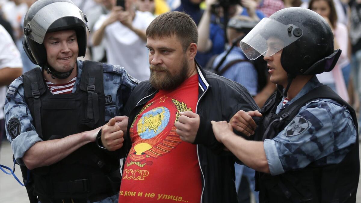 A protester is detained June 12 during a march in Moscow.
