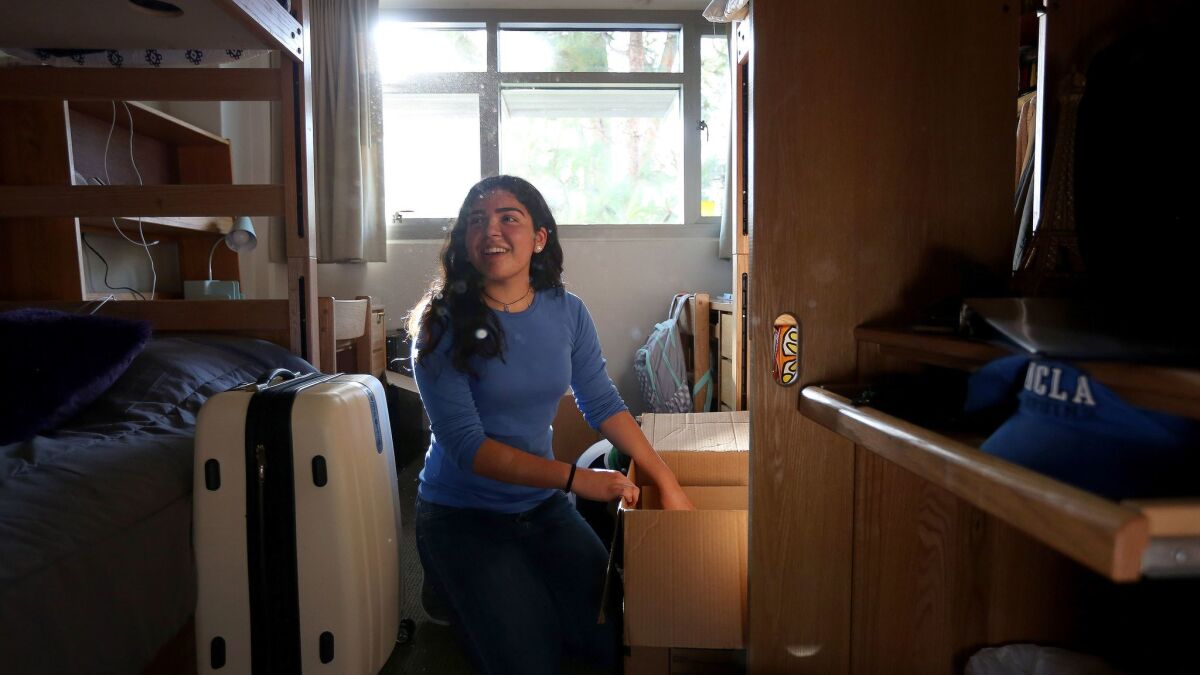 Desiree Felix, 18, unpacks her dorm room in Hedrick Hall at UCLA. Felix is the first in her family to attend college.