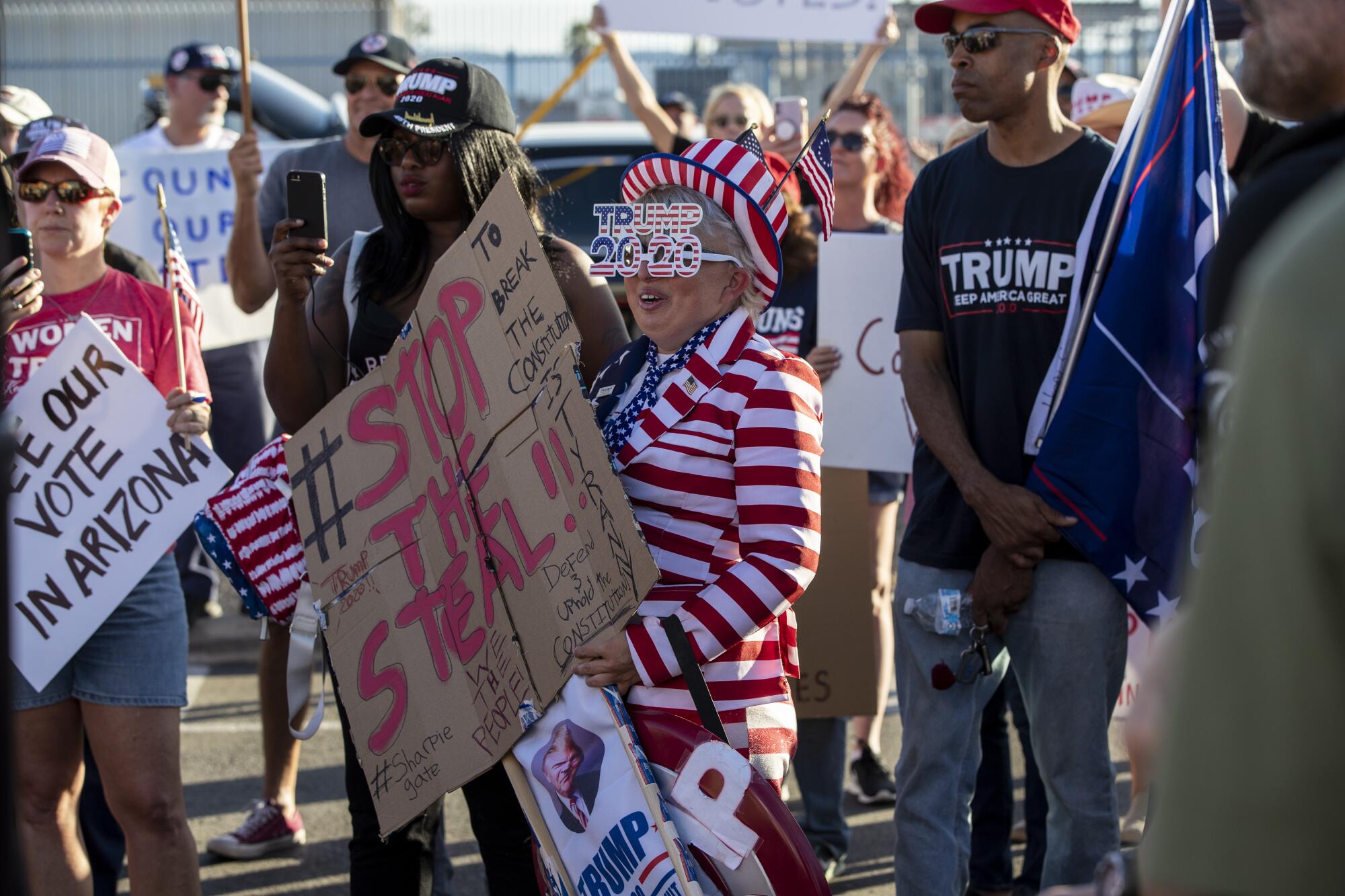 Trump supporters with some holding signs staying "Stop the Steal" protest at the Maricopa County Tabulation.