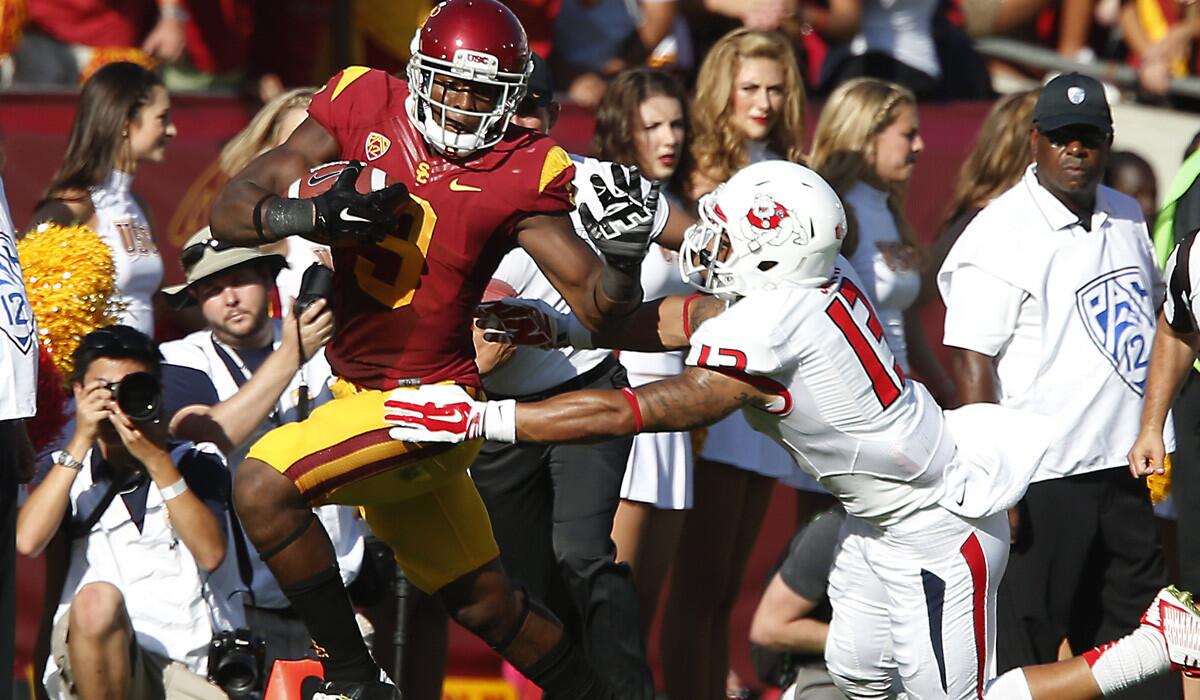 USC receiver JuJu Smith gets past Fresno State safety Derron Smith for a long gain in the season opener.