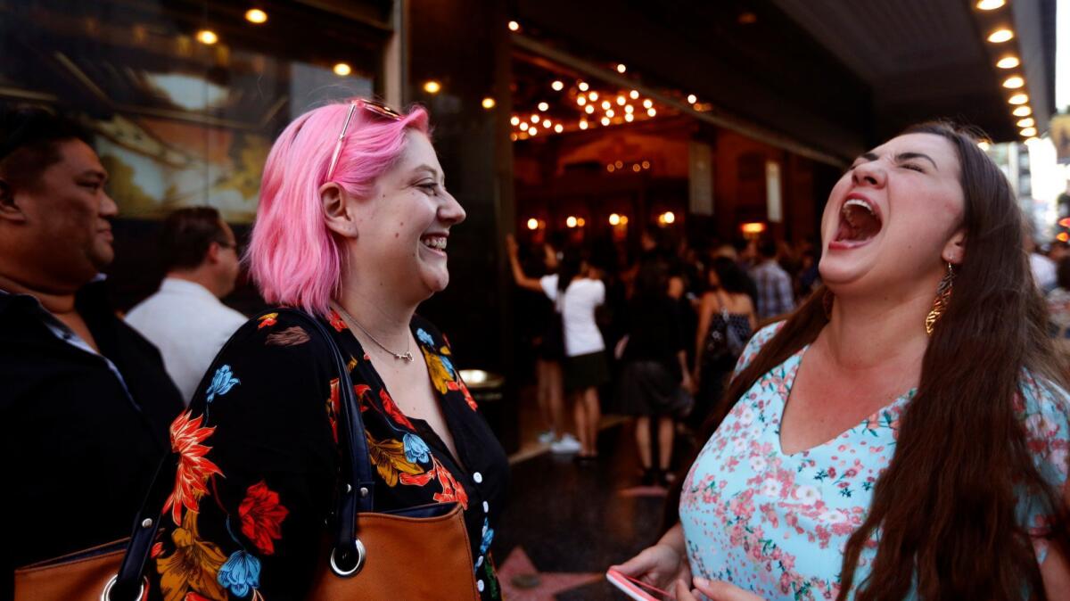 Candice Berge, right, finishes belting out a song from the musical, "Hamilton," while friend Amber Infante looks.