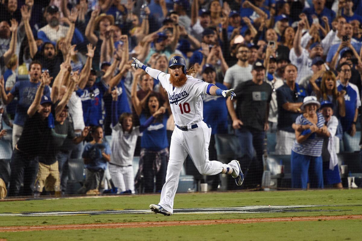 LOS ANGELES, CA - OCTOBER 15: Justin Turner #10 of the Los Angeles Dodgers celebrates after hitting a three-run walk-off home run in the ninth inning to defeat the Chicago Cubs 4-1 in game two of the National League Championship Series at Dodger Stadium on October 15, 2017 in Los Angeles, California.