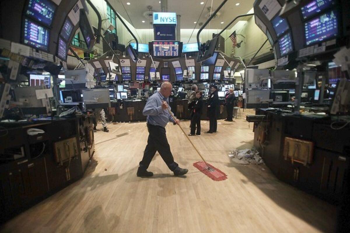 A worker cleans the floor of the New York Stock Exchange.