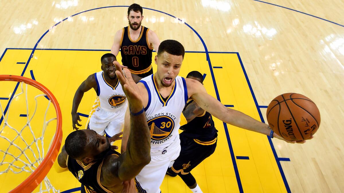 Stephen Curry of the Golden State Warriors goes up for a shot against LeBron James of the Cleveland Cavaliers in the first half in Game 2 of the 2016 NBA Finals on June 5 in Oakland.
