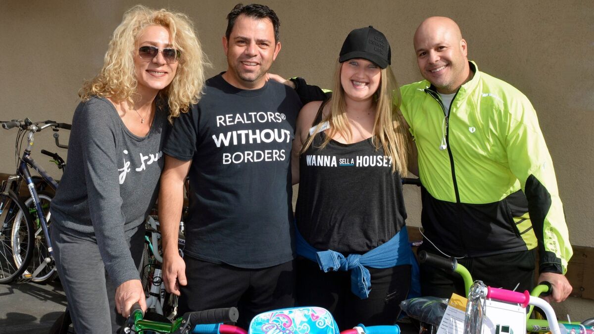 Karol Kochova, from left, Harry Timuryan, Courtney Korb and Robert Clark were among the local Realtors who made last Saturday's fifth annual bike drive a success.