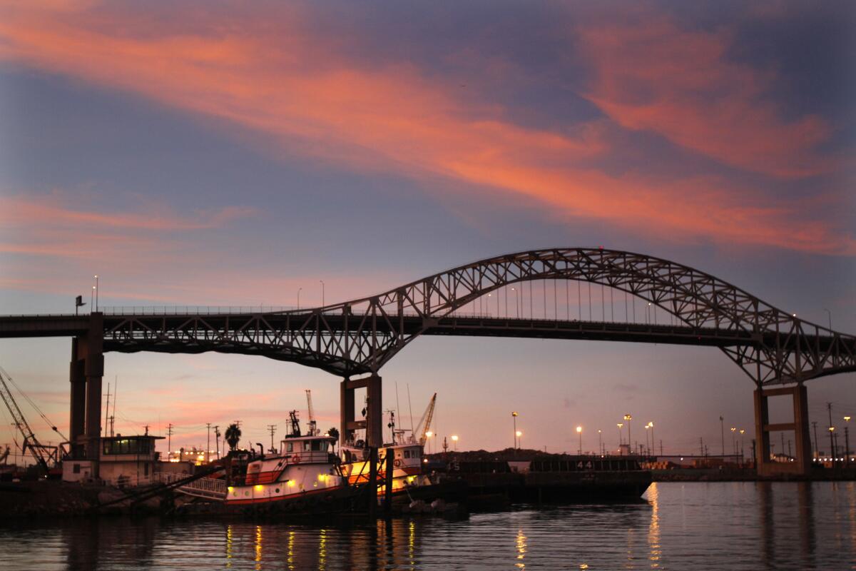 Tug boats tied up at their dock next to the Gerald Desmond bridge, which is being demolished to make way for a new span.