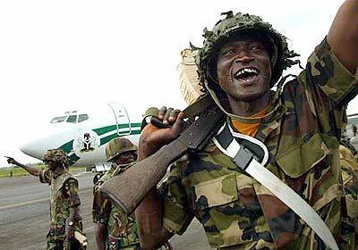 A Nigerian peacekeeper exults as former Liberian President Charles Taylor's plane prepares for takeoff. The indicted war crimes suspect and onetime warlord resigned and left for exile in Nigeria, bringing hope to war-weary civilians that years of brutal conflict would end.