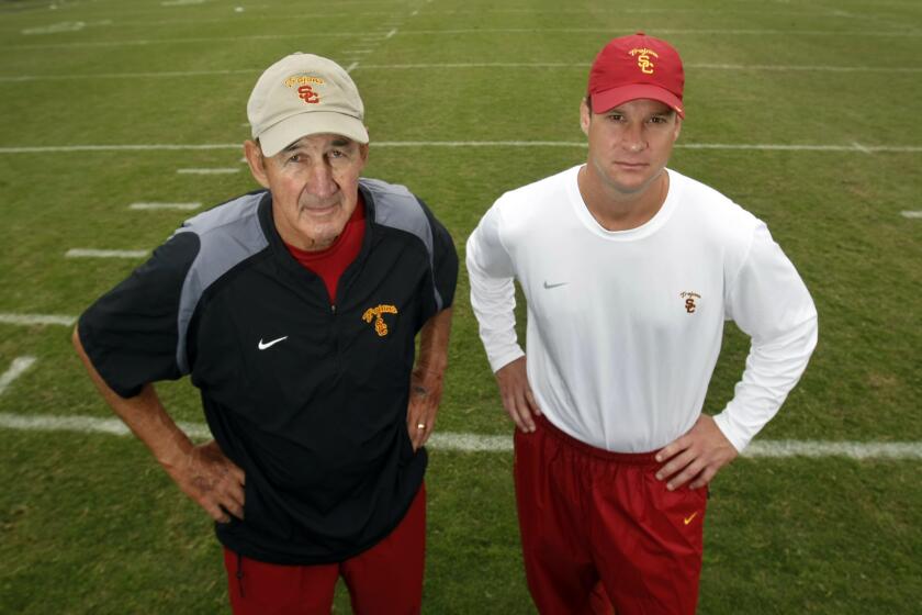 Schaben, Allen J. –– B581637487Z.1 LOS ANGELES, CA – OCTOBER 25, 2011: USC father–son coaching tandem: USC defensive coordinator Monte Kiffin, left, and his son, head football coach Lane Kiffin after practice at USC. It is an extremely rare situation –– a highly regarded father with decades of NFL and college coaching experience working for his son. ( Allen J. Schaben / Los Angeles Times)