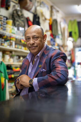 A man poses for a portrait in a store.