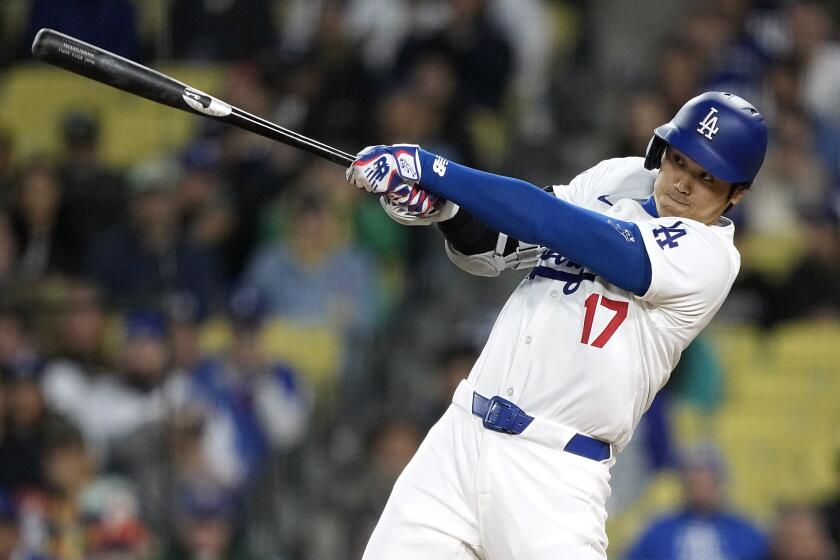Los Angeles Dodgers' Shohei Ohtani hits a solo home run during the first inning.