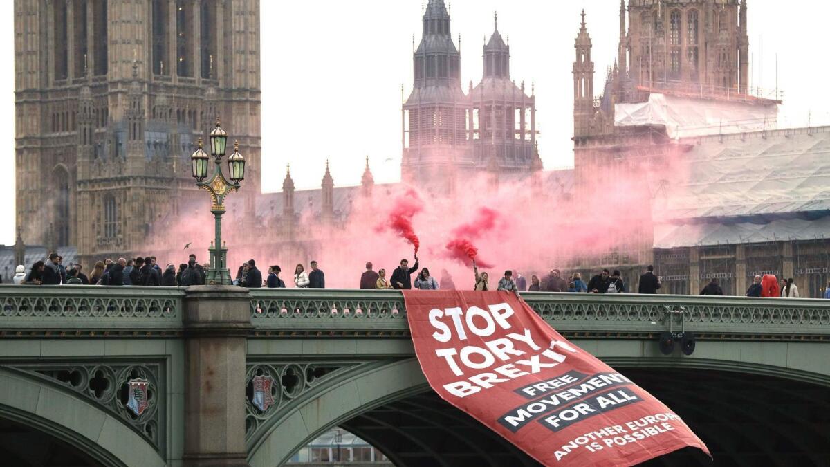Anti-Brexit campaigners unfurl a banner on Westminster Bridge in front of the Houses of Parliament in London on Thursday.