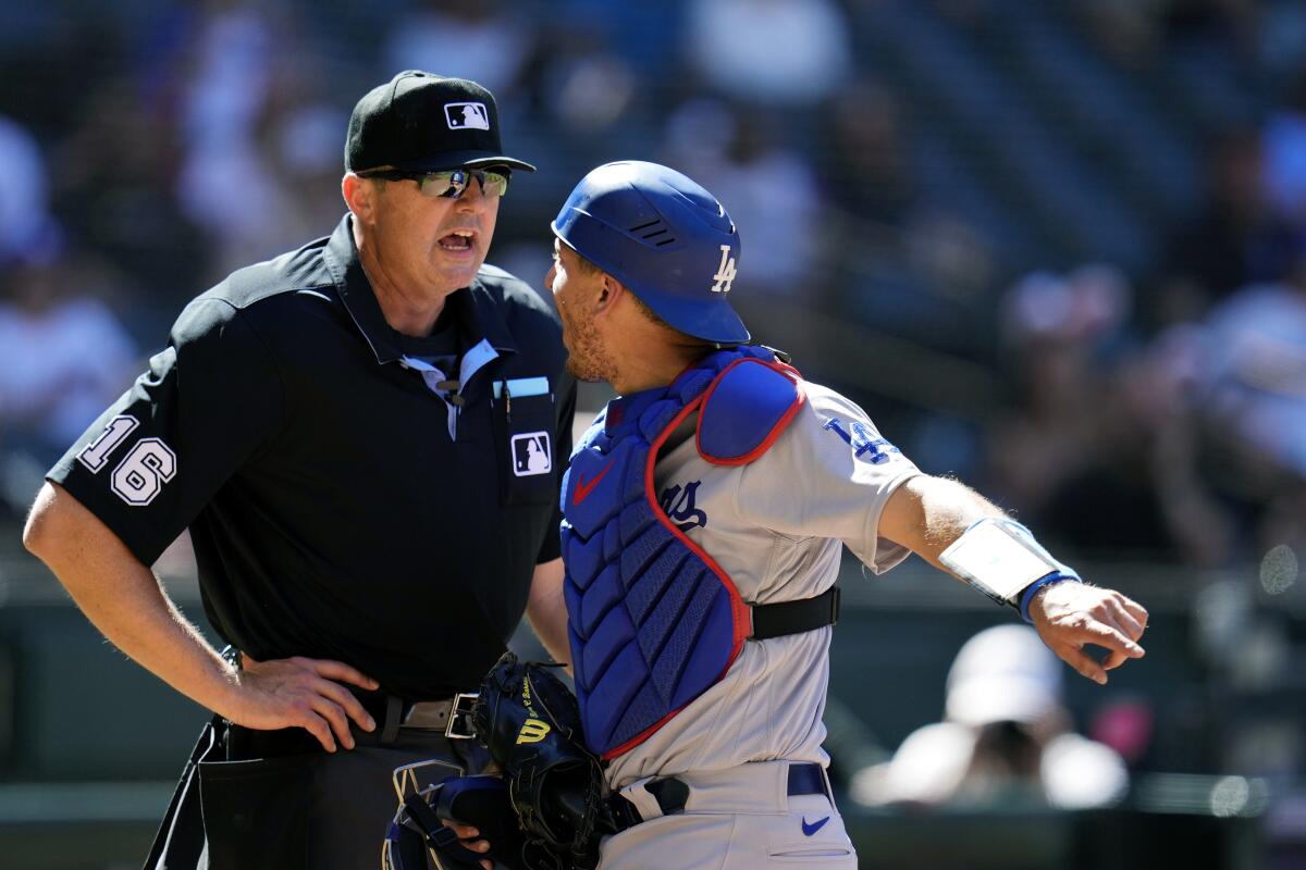 Dodgers catcher Austin Barnes, right, argues with umpire Lance Barrett after Barnes was ejected Sunday.