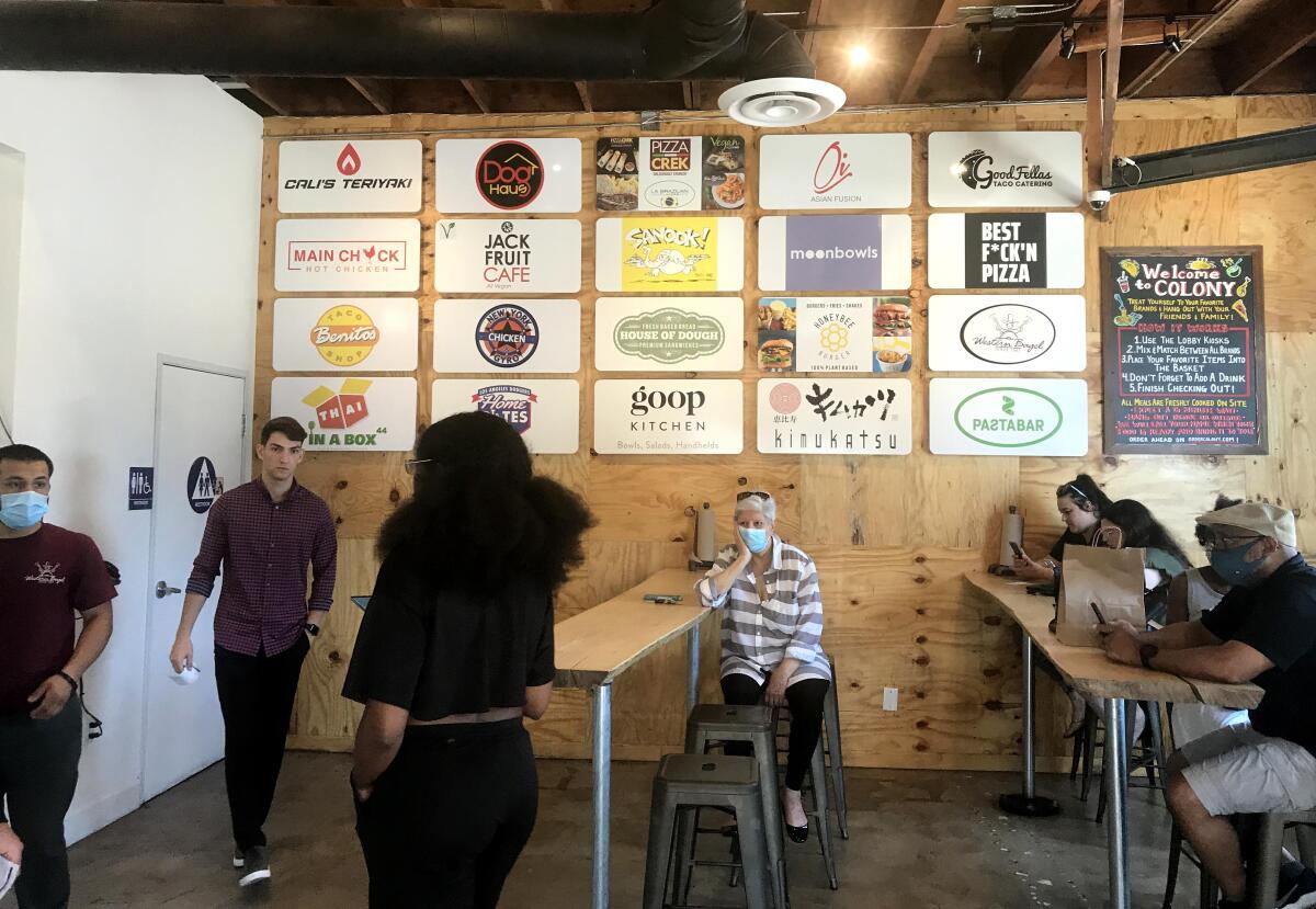 Customers wait for their food at the Colony on Santa Monica Boulevard on July 1. 