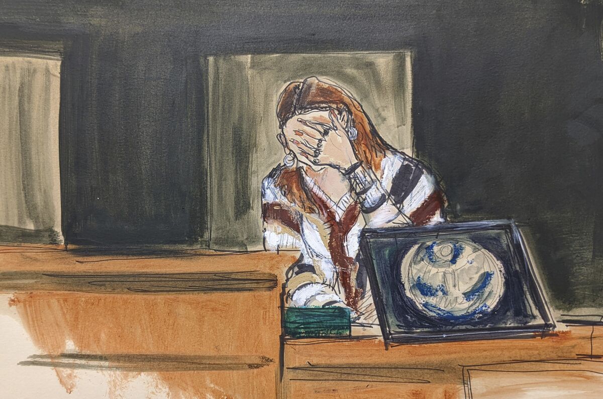 In this courtroom sketch, a witness testifying under the pseudonym "Carolyn," breaks down on the witness stand testifying about her experiences with Jeffery Epstein, during proceedings in Ghislaine Maxwell's sex-abuse trial, in New York, Tuesday, Dec. 7, 2021. (AP Photo/Elizabeth Williams)