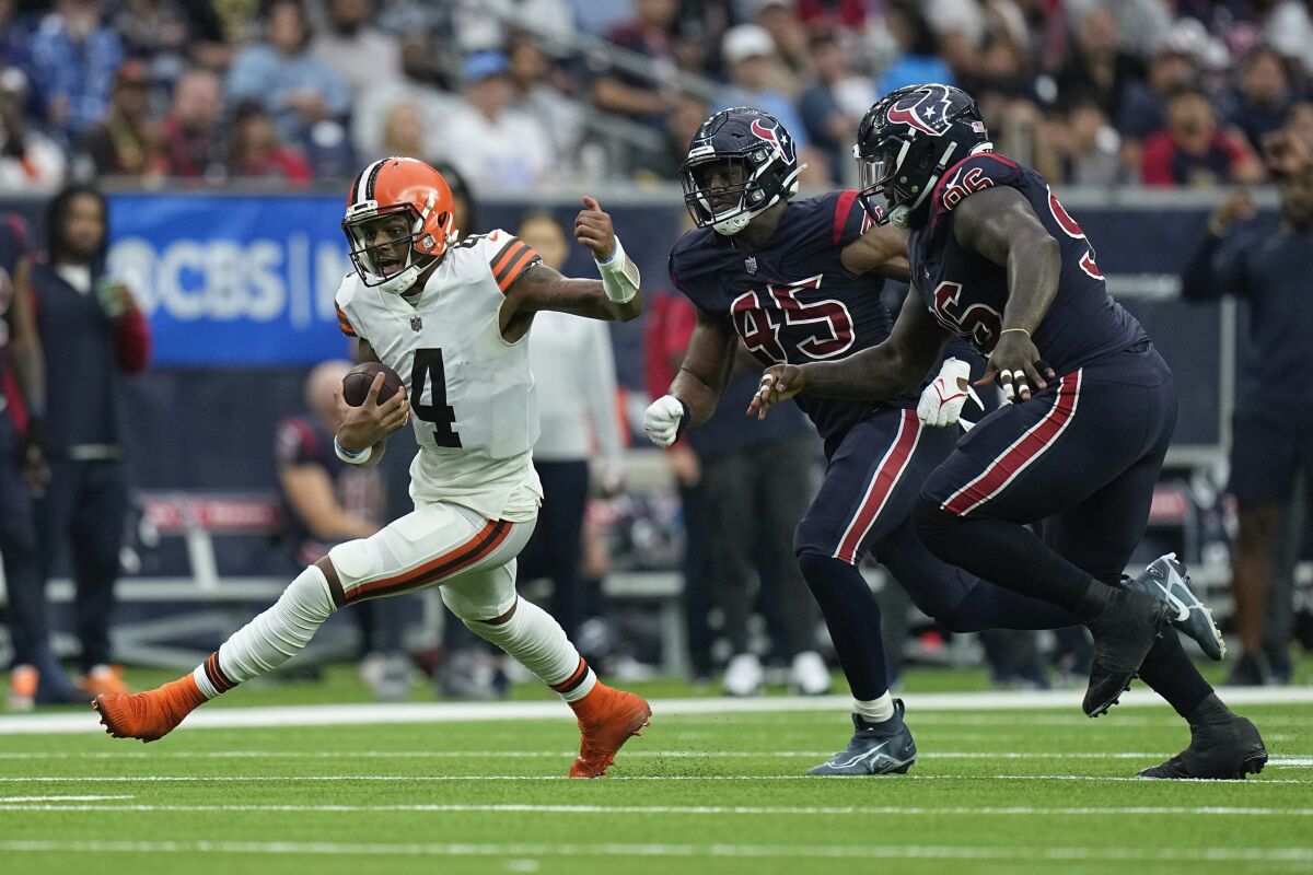 Cleveland Browns quarterback Deshaun Watson (4) evades Houston Texans guard Kenyon Green (59) and defensive tackle Maliek Collins during the second half of an NFL football game between the Cleveland Browns and Houston Texans in Houston, Sunday, Dec. 4, 2022. (AP Photo/Eric Gay)