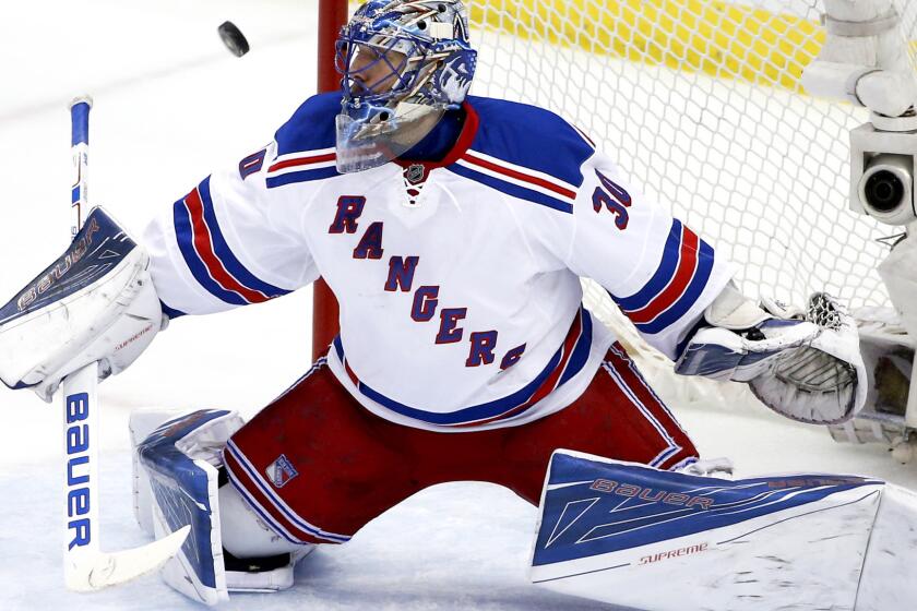 Rangers goalie Henrik Lundqvist blocks a shot by the Penguins during the first period Saturday.