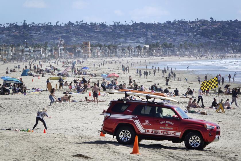 Beach goers enjoy a sunny day in Pacific Beach on March 17, 2020.