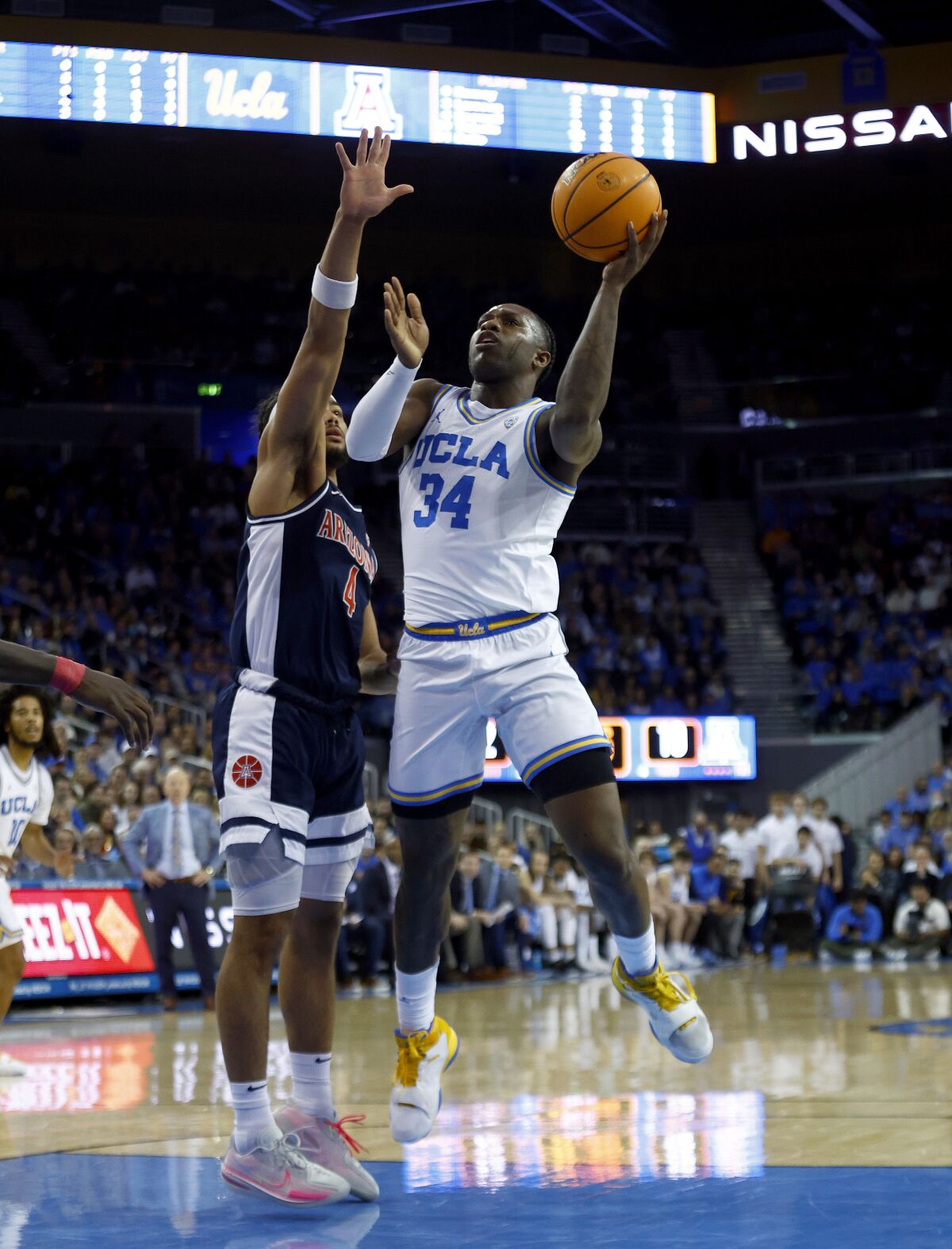 The Bruins' David Singleton stepped up a shot against the Wildcats' Kylan Boswell.