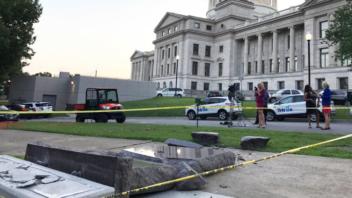 The Ten Commandments monument outside the state Capitol in Little Rock, Ark., is blocked off on June 28 after someone crashed into it with a vehicle.