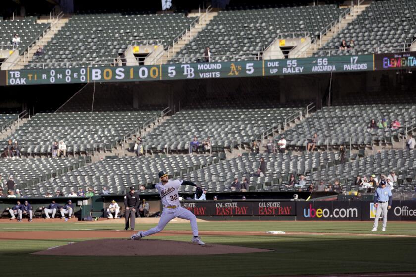Oakland Athletics starting pitcher James Kaprielian (32) throws against the Tampa Bay Rays in Oakland on Monday.
