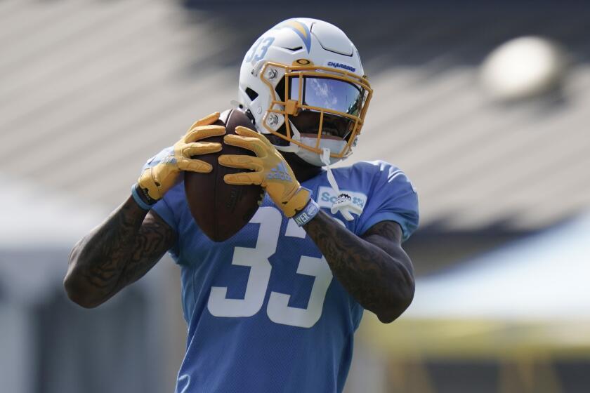 Los Angeles Chargers safety Derwin James makes a catch during an NFL football camp practice.
