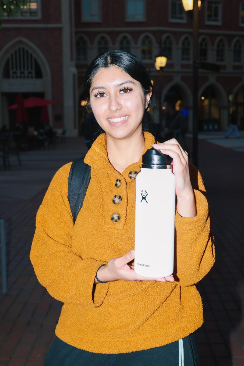 Leslie Compean poses for a portrait with a Hydro Flask water bottle at USC University Village.