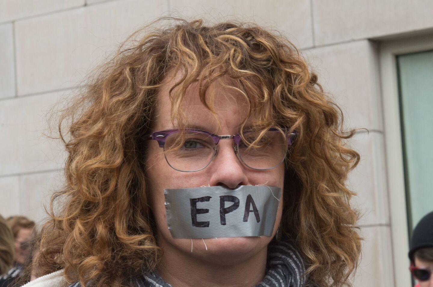An activist wears tape with a message over her mouth at a rally before the March for Science in New York.