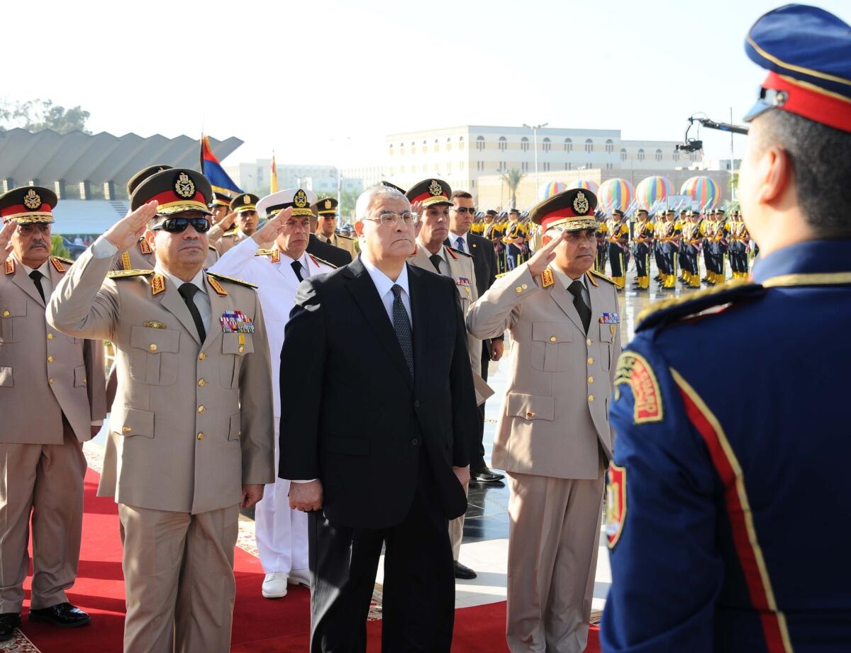 Egypt's interim president Adly Mansour, center, with Defense Minister Colonel General Abdul Fattah Sisi, left, and Chief of Staff Sedki Sobhi.