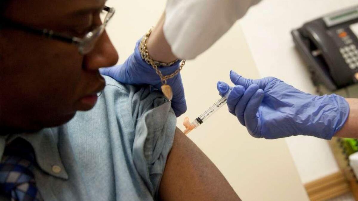 A patient receives a flu shot from a nurse practitioner in Rockville, Md., in 2010.