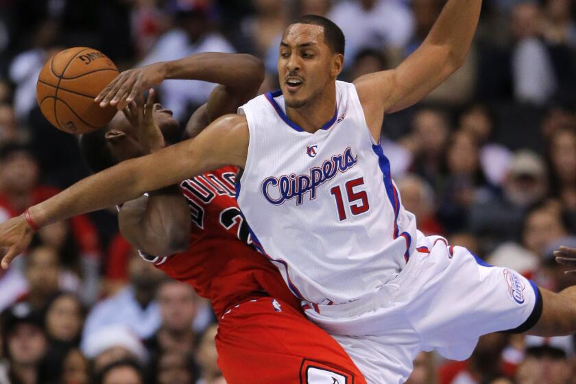 Clippers center Ryan Hollins, right, fouls Chicago Bulls guard Jimmy Butler during a game in November 2012.