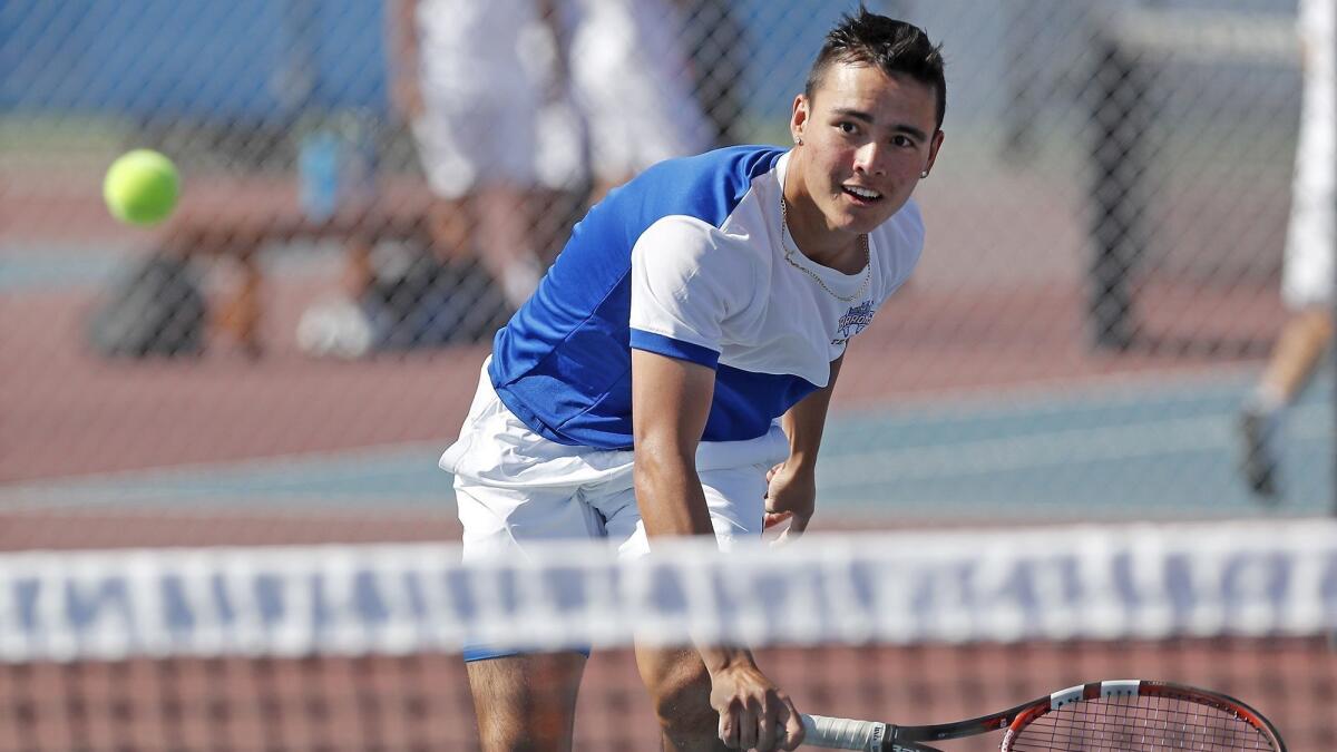 Fountain Valley High's Justin Pham, shown competing on April 17, won twice in doubles play on Wednesday to reach the semifinals of the Sunset League tennis tournament.