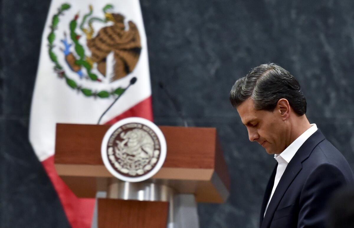 Mexican President Enrique Peña Nieto leaves after delivering a message to the media Wednesday after a meeting with parents of 43 missing students at the Los Pinos presidential palace in Mexico City.