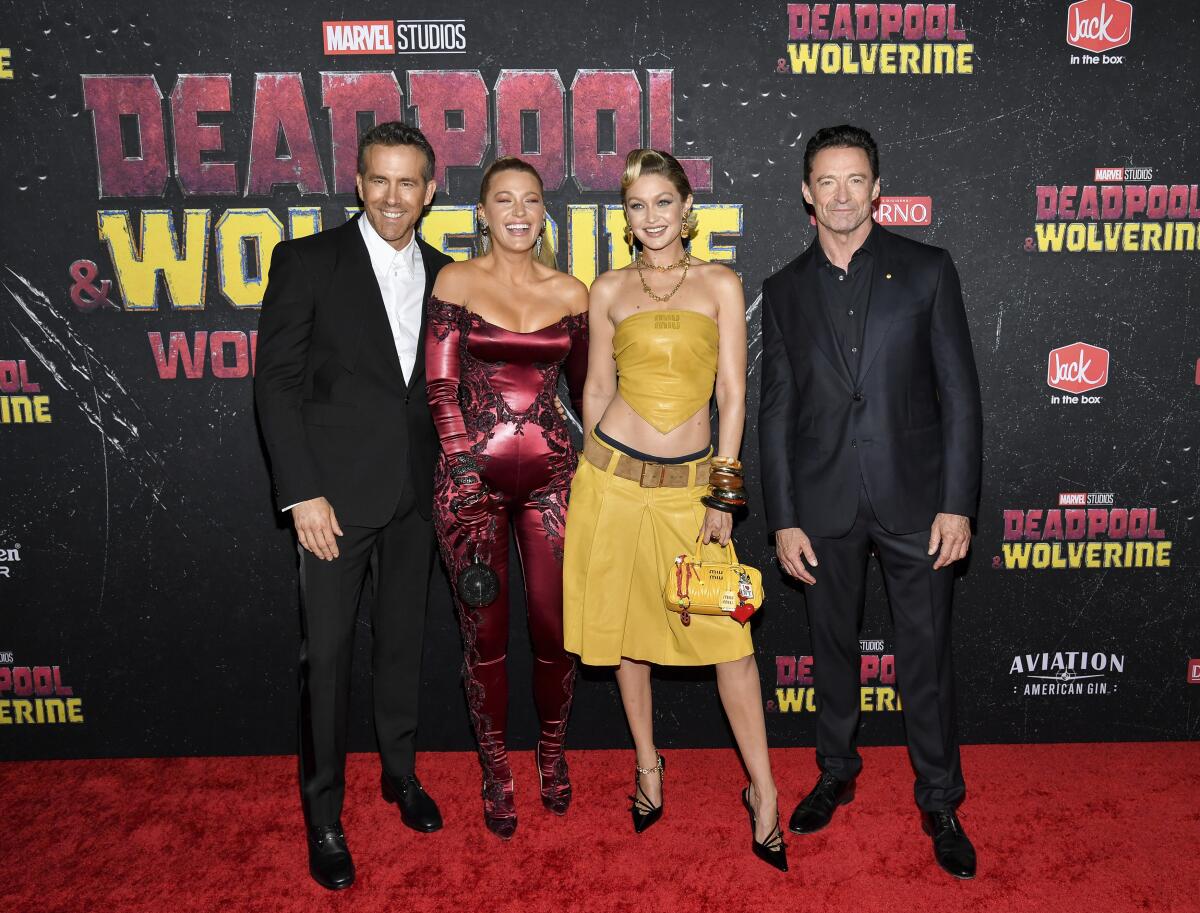 Ryan Reynolds, left, Blake Lively, Gigi Hadid and Hugh Jackman pose on the red carpet for "Deadpool & Wolverine"