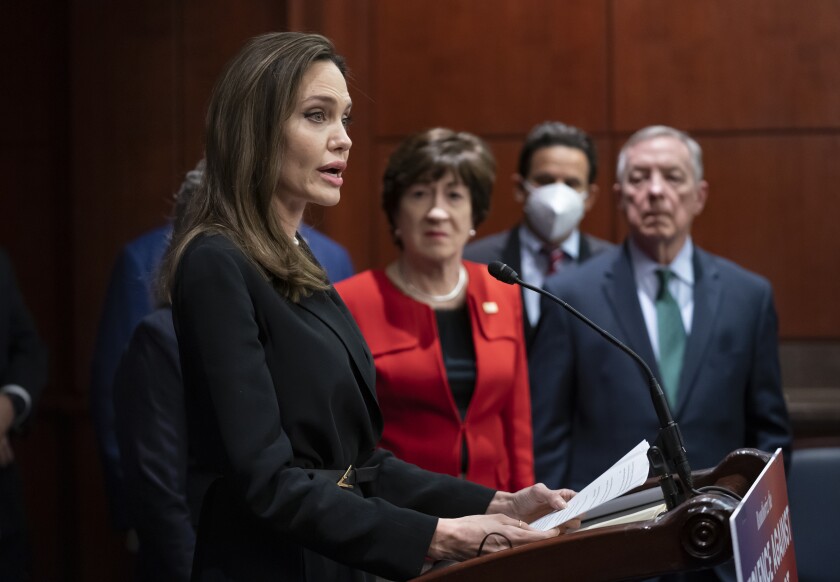 Actress and activist Angelina Jolie, left, joins, from left, Sen. Susan Collins, R-Maine, Sen. Brian Schatz, D-Hawaii, and Senate Judiciary Chairman Dick Durbin, D-Ill., at a news conference to announce a bipartisan update to the Violence Against Women Act, at the Capitol in Washington, Wednesday, Feb. 9, 2022. (AP Photo/J. Scott Applewhite)