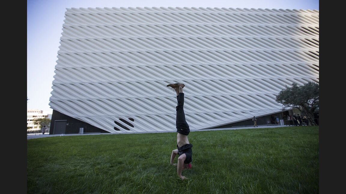 Blakey Olsen of Laguna Beach practices yoga in front of the Broad Contemporary Art Museum as temperatures set a record at 87 degrees in downtown L.A. on Tuesday.