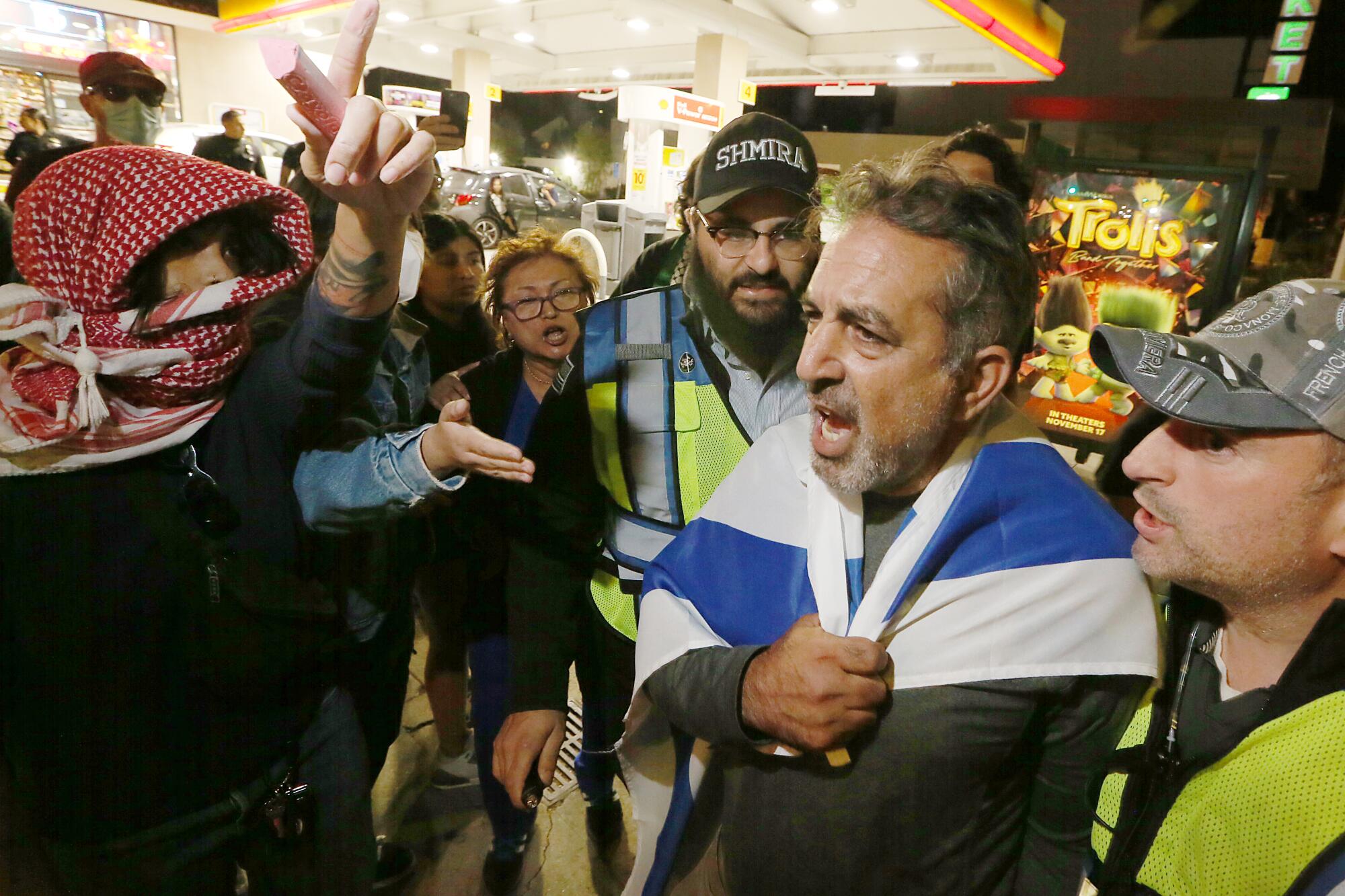 Pro-Israel and pro-Palestinian protesters confront each other outside the Museum of Tolerance 