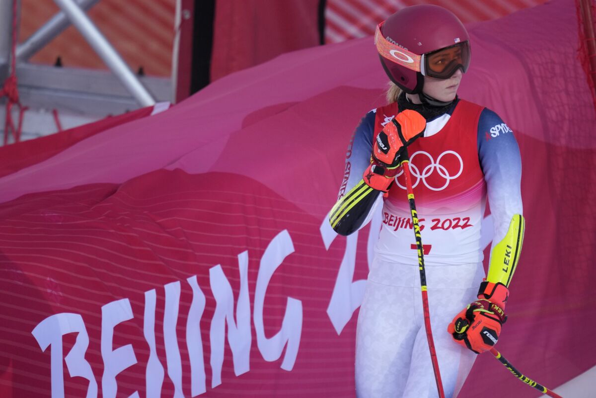 Mikaela Shiffrin leaves the course after missing a gate and skiing out of bounds during her first giant slalom run.