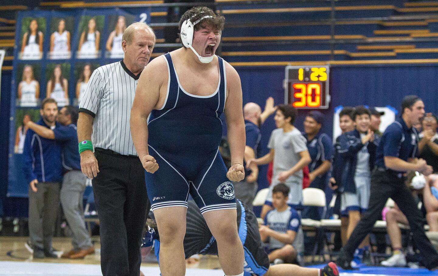 Newport Harbor High's Eddie Rios celebrates after beating Corona del Mar's Luke Anderson in the 285-pound division in a Wave League match on Wednesday.