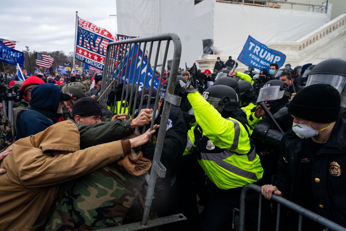 U.S. Capitol police officers try to hold back pro-Trump insurrectionists on Jan. 6, 2021. 