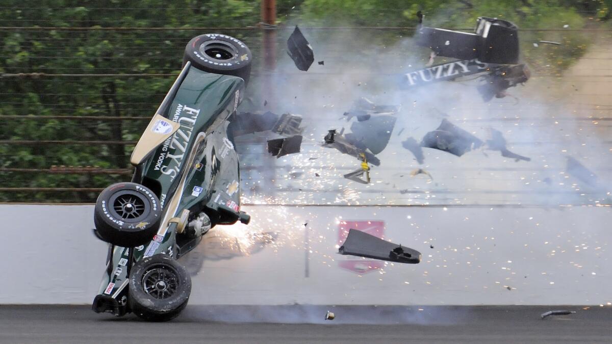 Ed Carpenter hits the wall at Turn 2 of the Indianapolis Motor Speedway during a practice session Sunday in preparation for next weekend's Indianapolis 500.