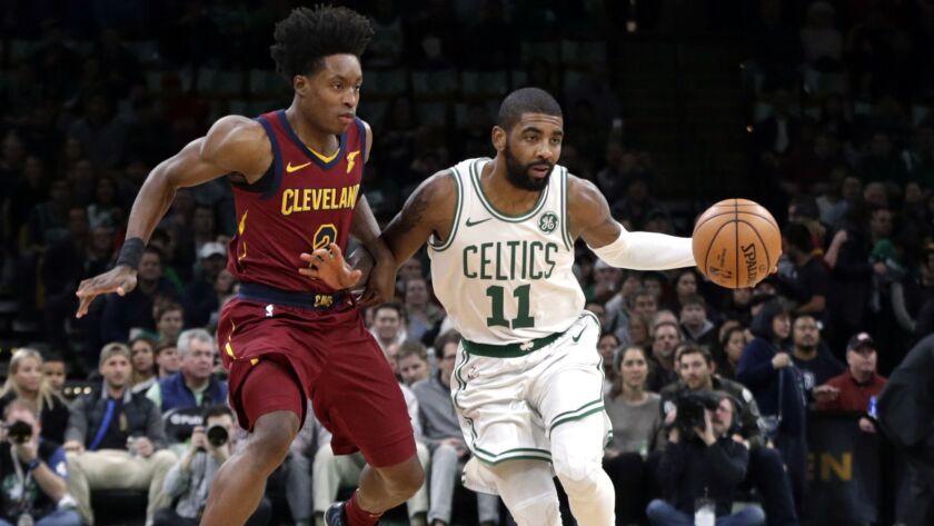 Boston Celtics guard Kyrie Irving (11) advances the ball downcourt against Cleveland Cavaliers guard Collin Sexton (2) during the first half.