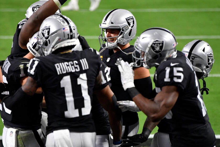 Las Vegas Raiders quarterback Derek Carr #4 celebrates with wide receivers Henry Ruggs III.
