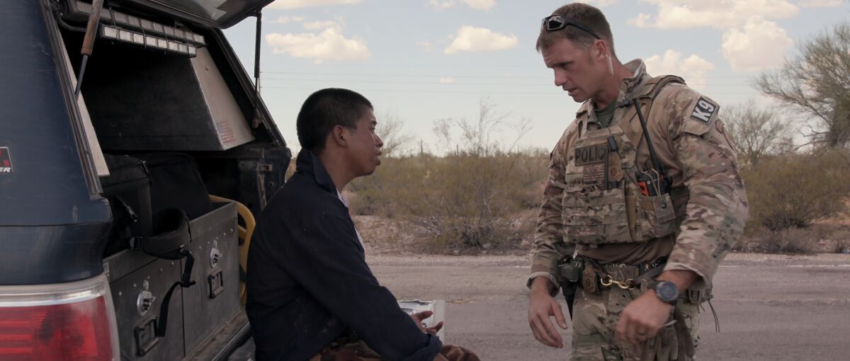 A migrant, left, seeks help in Tucson's desert in a moment from Netflix's "Immigration Nation."