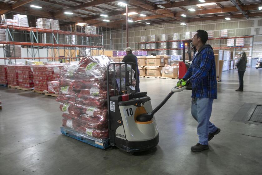 Feeding San Diego employee Raymond Diaz moved produce around with a pallet jack in their warehouse. Feeding San Diego CEO Vince Hall, announced on March 17th at their Mira Mesa headquarters, several new emergency food distributions due to the increasing demand because of the COVID-19 virus outbreak. Feeding San Diego is a non-profit food rescue and distribution organization.