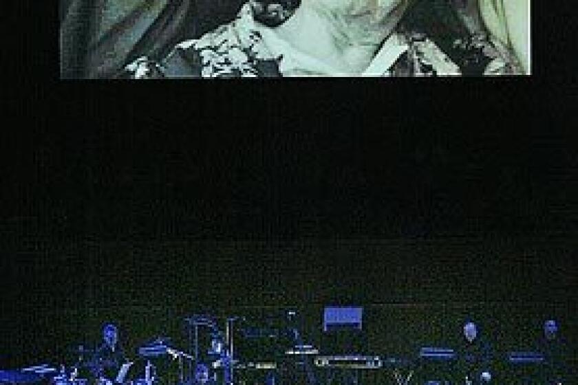 Michael Tilson Thomas stands before a contingent of the Los Angeles Philharmonic beneath a projection of an early photo of himself with his celebrated grandmother, Bessie. The San Francisco Symphony's music director is paying tribute to his grandparents at Walt Disney Concert Hall with The Thomashefskys: Music and Memories of a Life in the Yiddish Theater."