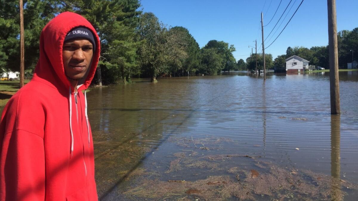 Demonte White, 21, in front of his inundated home in Tarboro, N.C.