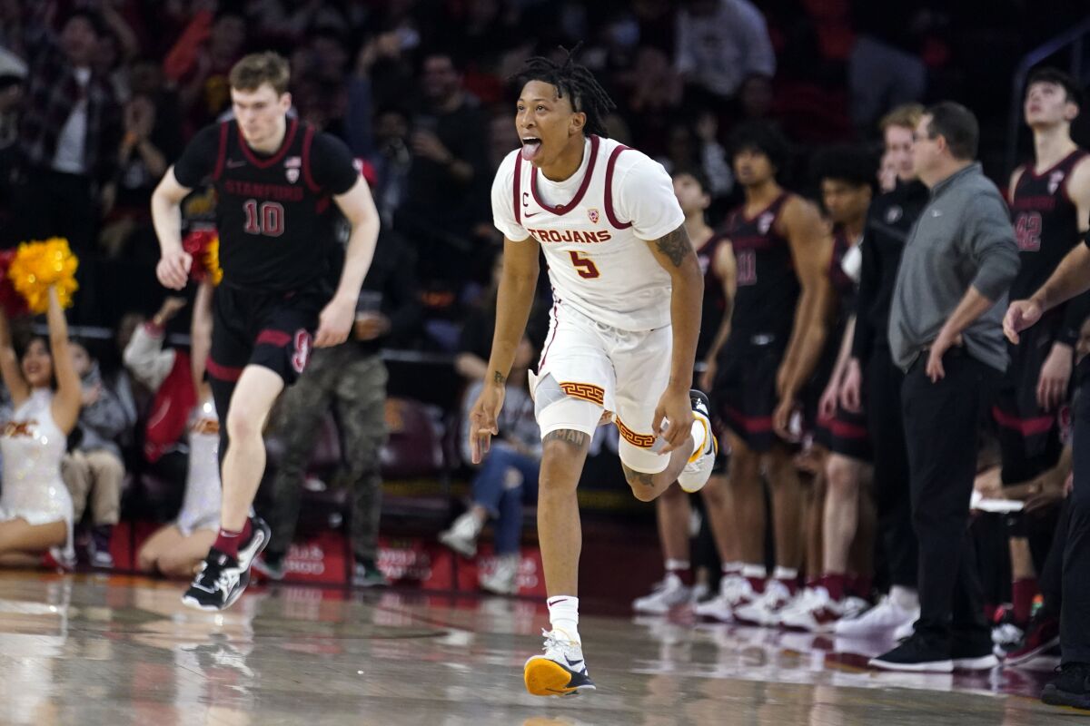 USC guard Boogie Ellis celebrates after making a three-pointer in the first half Saturday against Stanford.