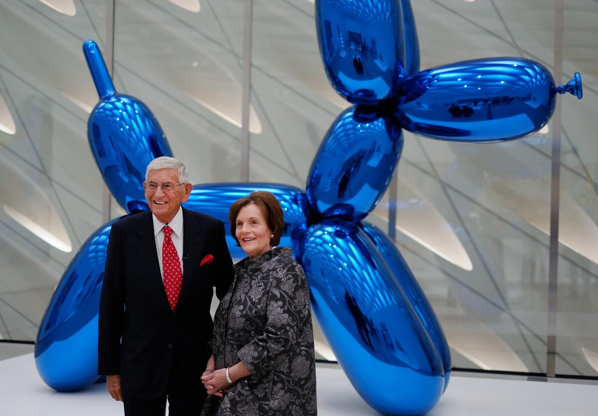 Eli Broad and his wife Edythe in front of the Jeff Koons sculpture "Balloon Dog (Blue)" at the opening of the Broad in 2015. 