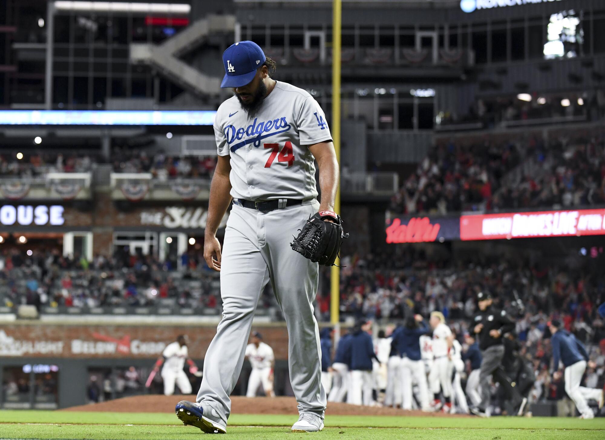 Dodgers relief pitcher Kenley Jansen walks off the field after allowing a walk-off single to Braves' Eddie Rosario